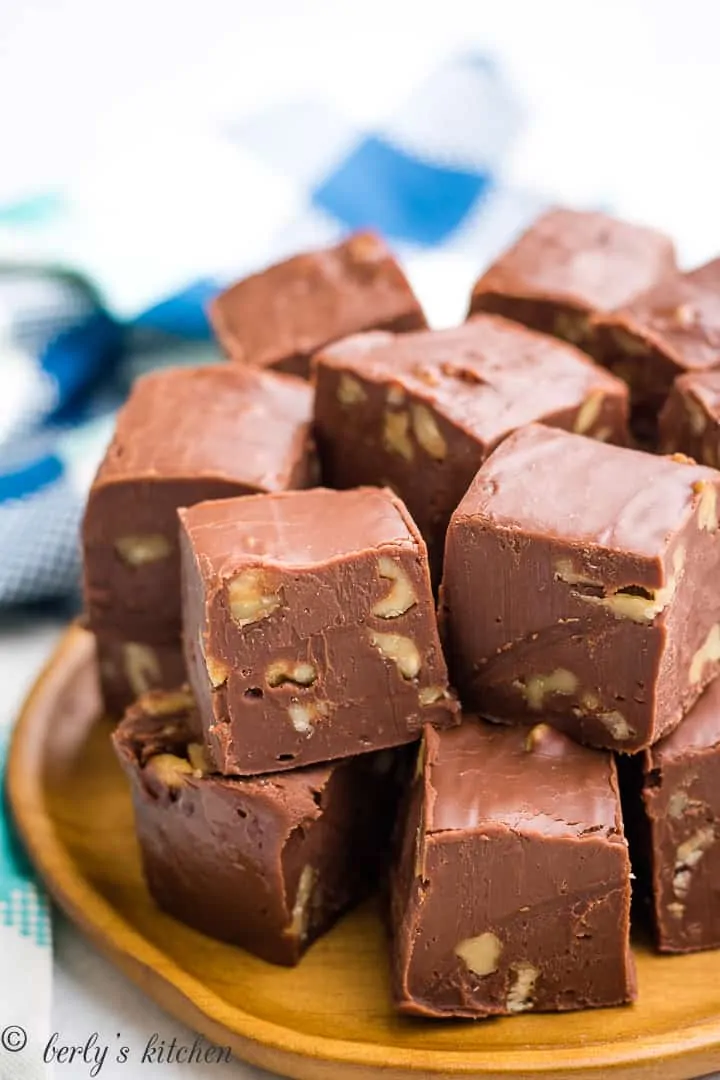 The chocolate fudge cut into cubes on a plate.