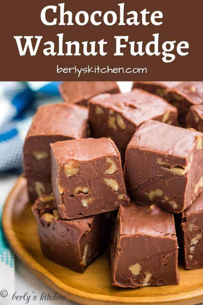 Chocolate walnut fudge cut into squares and served on a plate.