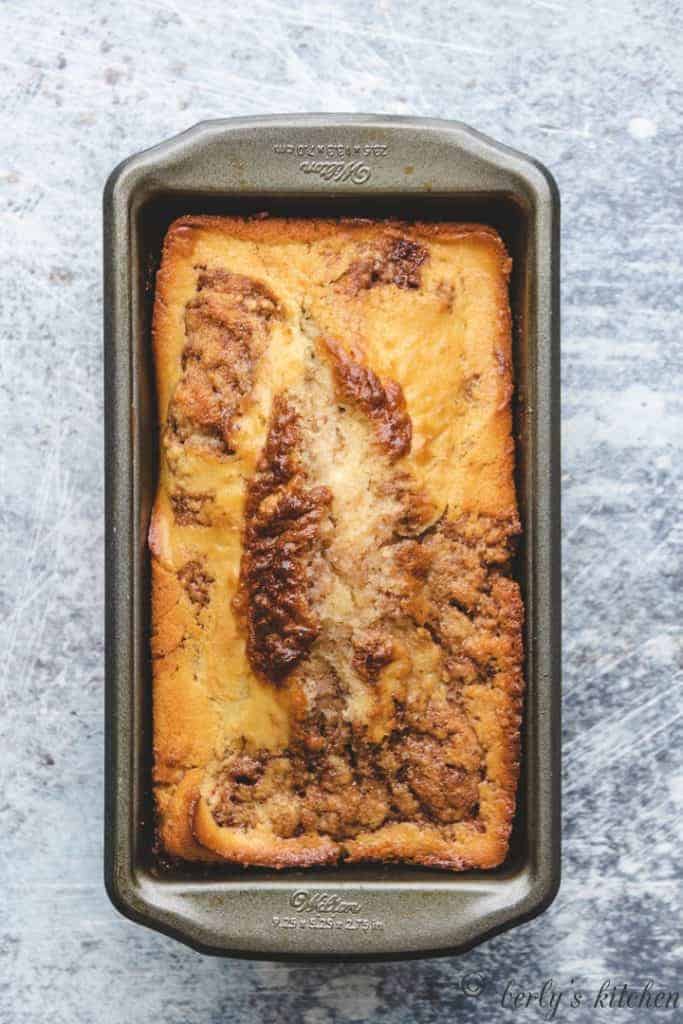 The fresh baked bread cooling in a loaf pan.