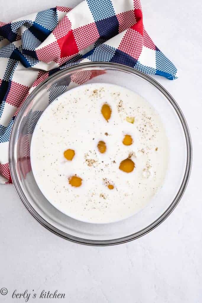 Eggs and milk in a large mixing bowl.