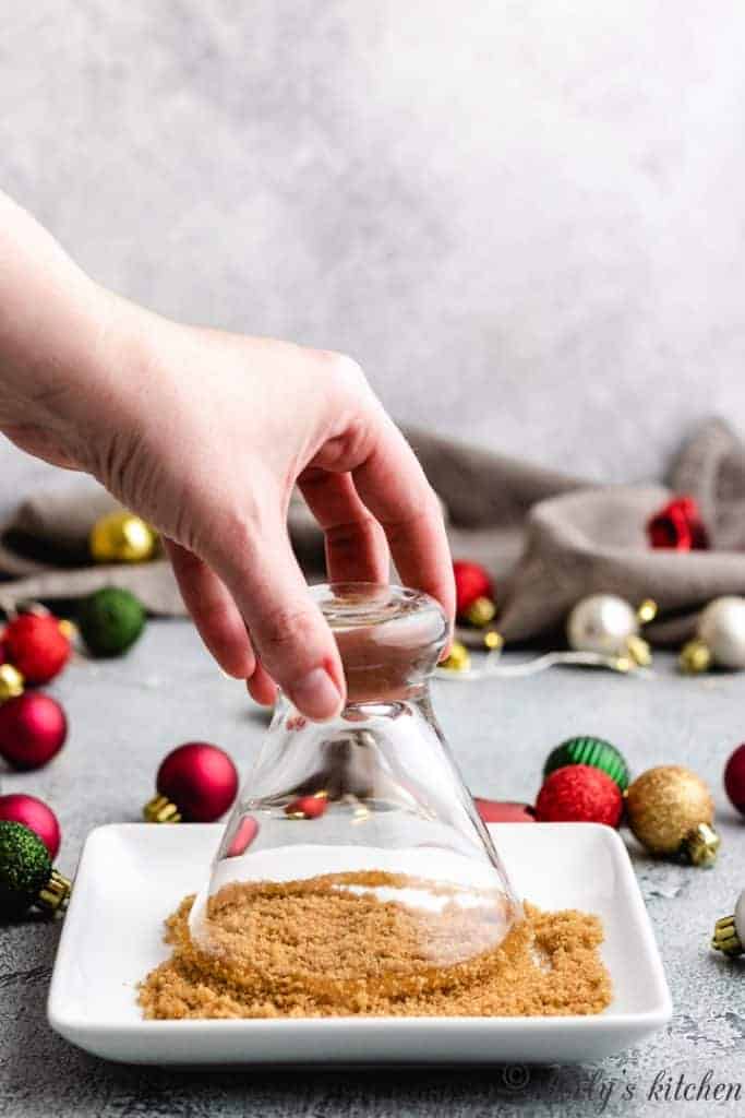 Eggnog Martini The sticky rim being dipped into cinnamon and brown sugar.