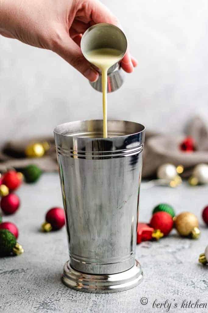 Eggnog Martini Eggnog being poured into a cocktail shaker.