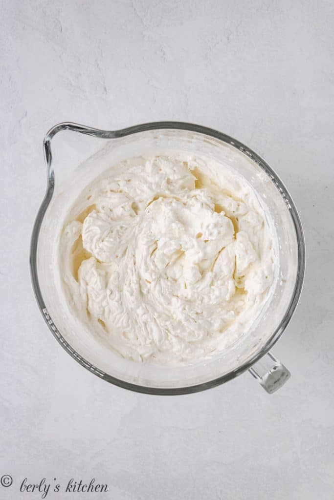 Whipped cream in a large mixing bowl.
