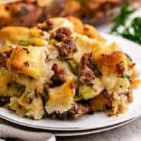 A piece of sausage stuffing on a white plate.