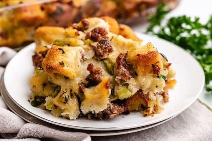 A piece of sausage stuffing on a white plate.