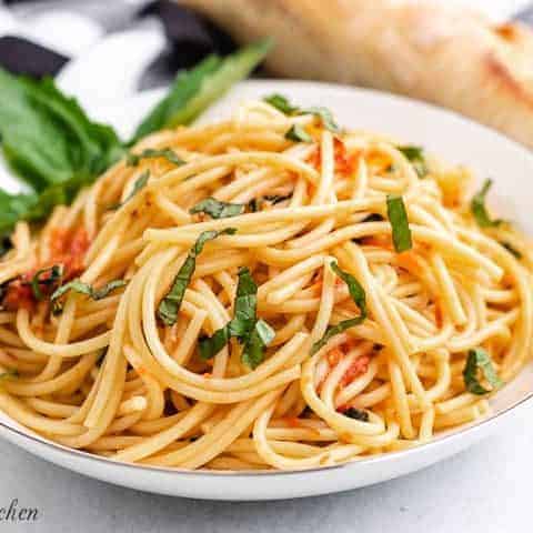 A serving of tomato basil pasta in a large bowl.