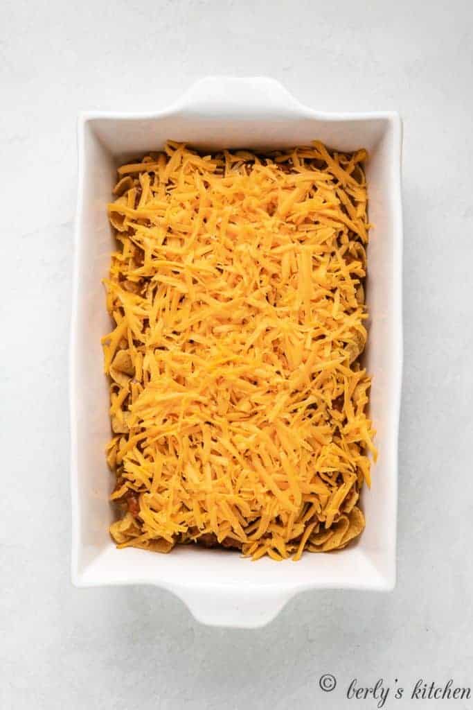 Cheddar cheese sprinkled over the chili and chips.