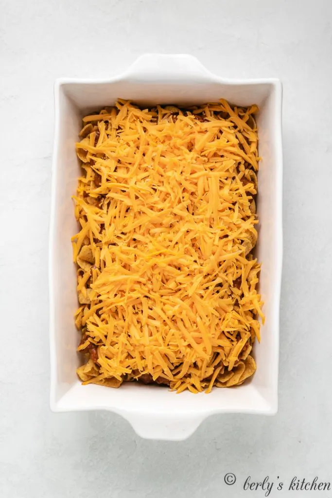 Cheddar cheese sprinkled over the chili and chips.