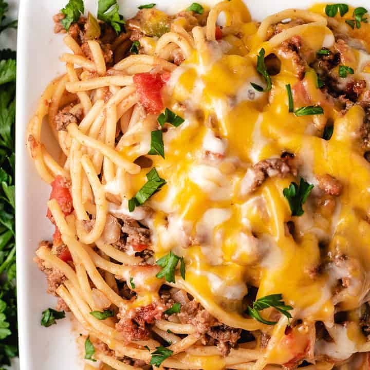 Top down view of spaghetti with cheese.