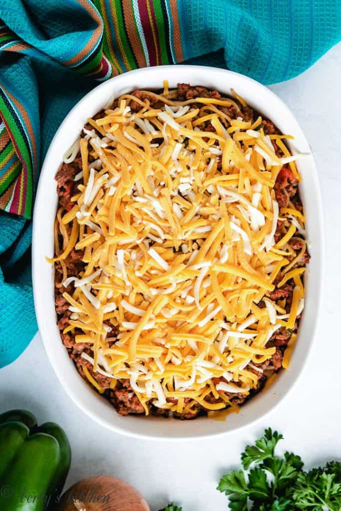 Shredded cheese on top of spaghetti casserole.