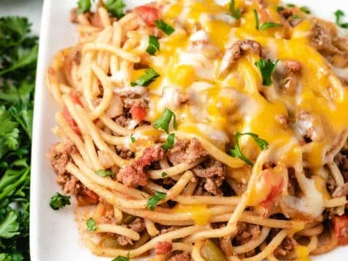Scoops of ground beef pasta with cheese on a plate.