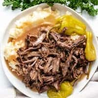 Pot roast and mashed potatoes with pepperoncinis.