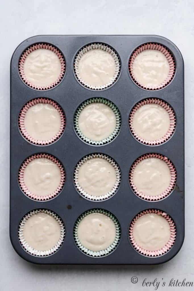 The cupcake batter transferred to decorative liners.
