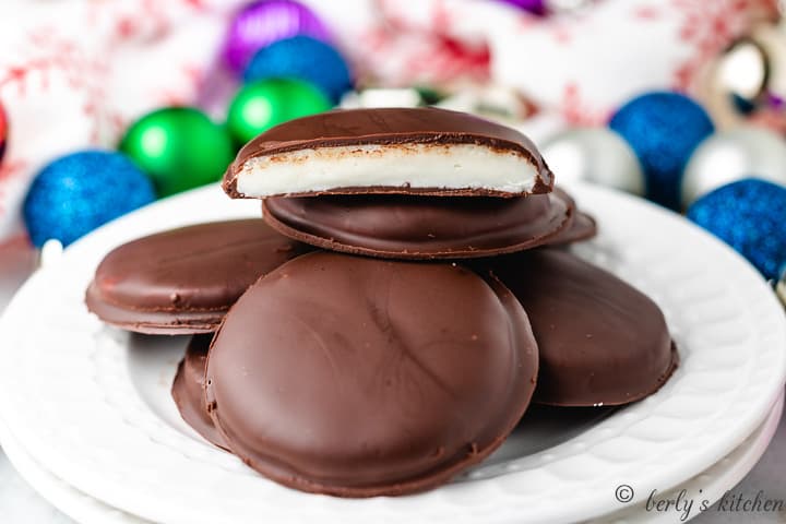 A pile of peppermint patties on a white plate.