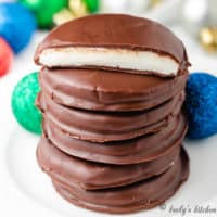 Six peppermint patties stacked on a plate.