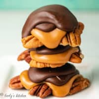 Three turtle candies stacked on a plate.
