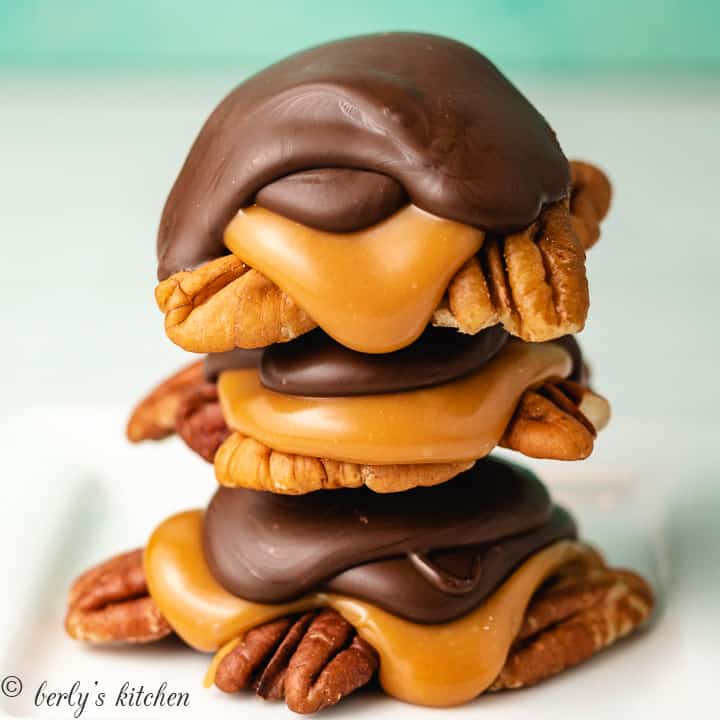 Three turtle candies stacked on a plate.