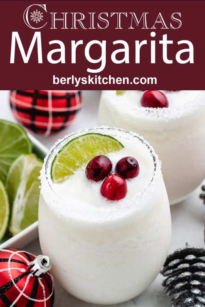 A white Christmas margarita surrounded by holiday decorations.