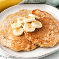 Pancakes and fruit on a plate.