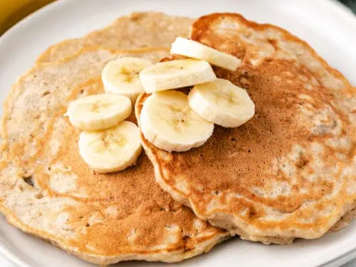 Pancakes and fruit on a plate.