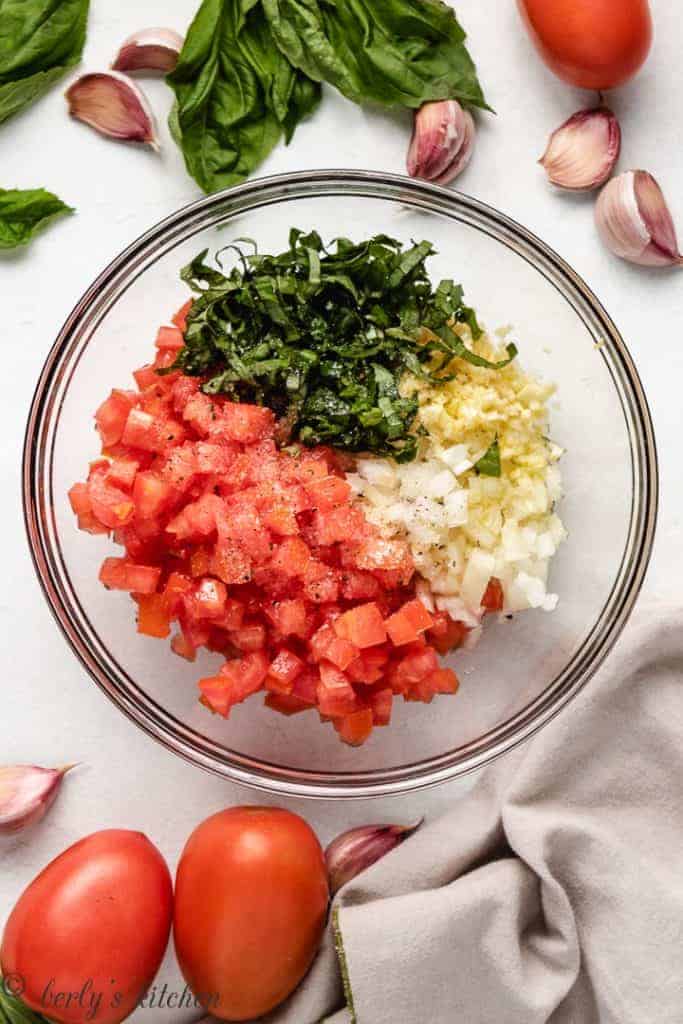 Ingredients for easy bruschetta in a glass bowl.