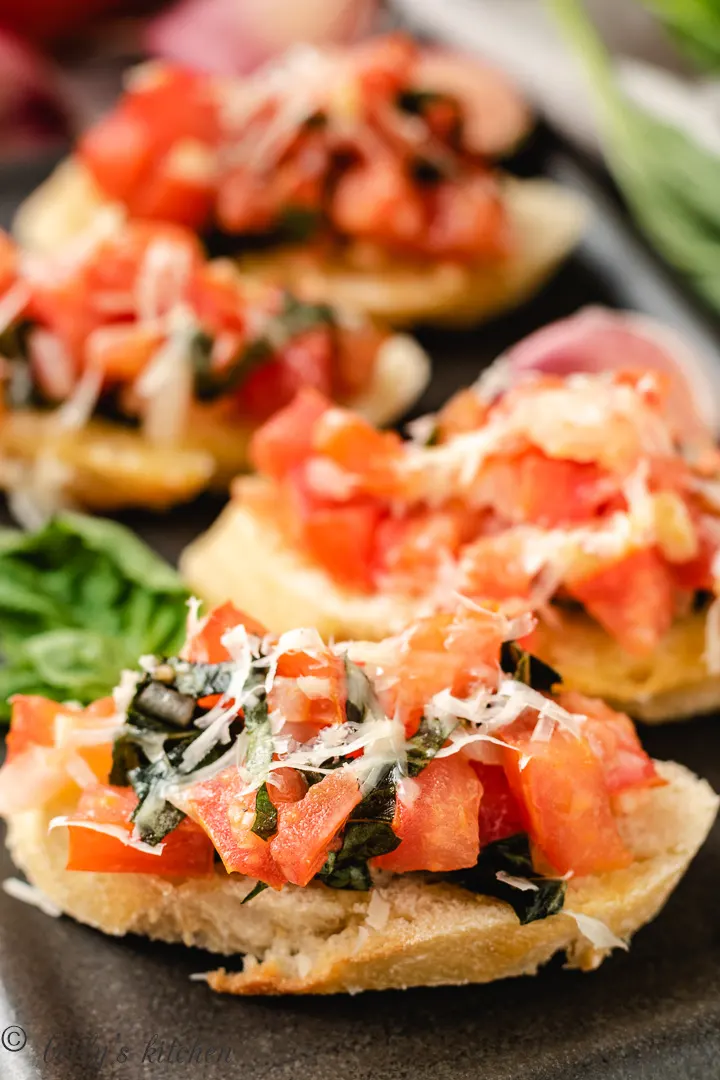Fresh bruschetta with tomatoes, onions, garlic, and basil on toast.
