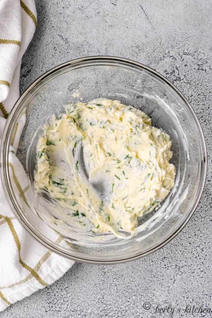 Garlic butter mixed in a glass bowl.