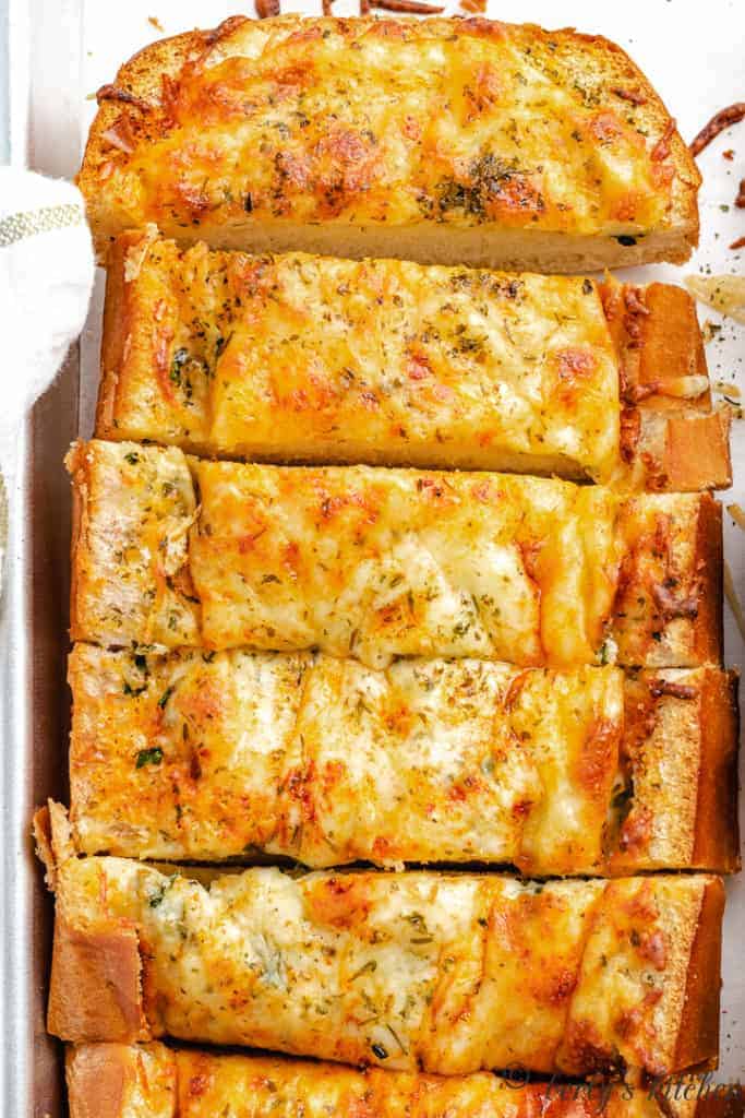 Top down view of a loaf of bread with cheese sliced.