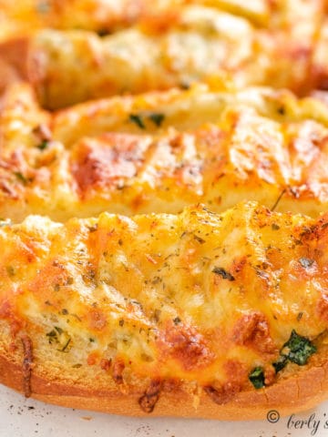 Cheesy Garlic Bread slices on a pan.