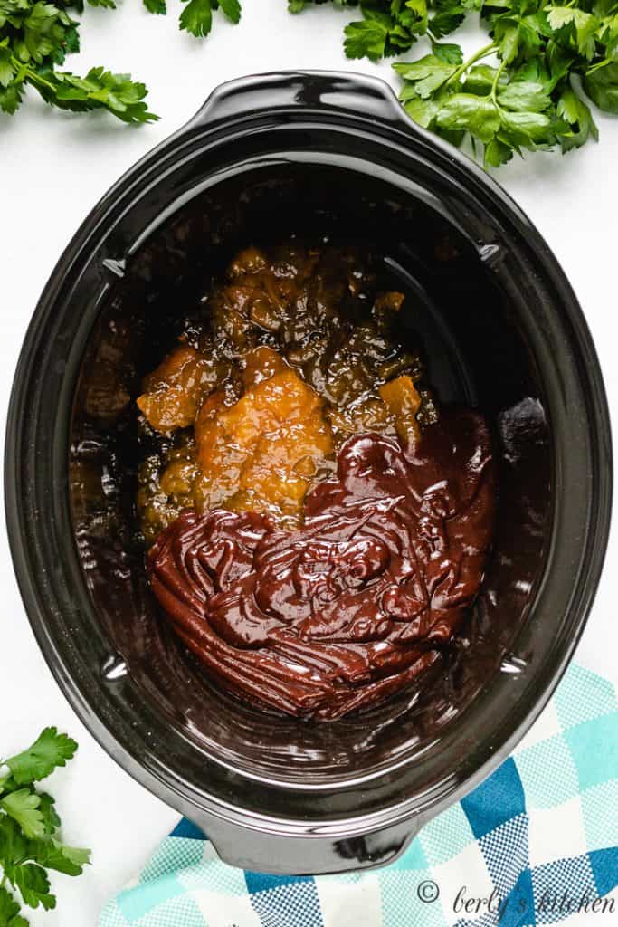 Top down view of jelly and bbq sauce in a slow cooker.