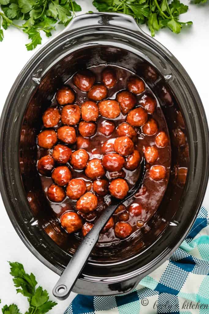 Cooked meatballs in a slow cooker.