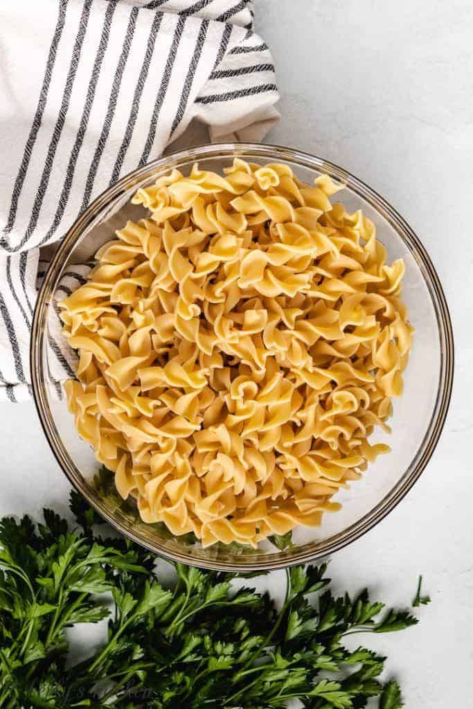 Cooked egg noodles in a glass bowl.