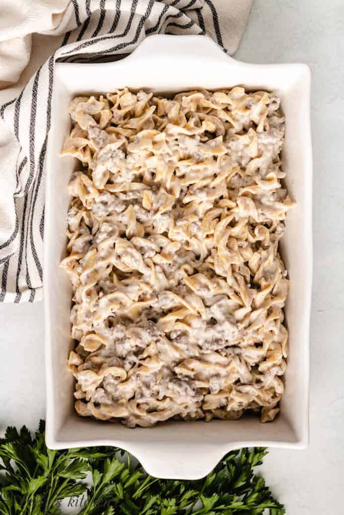 Ground beef and egg noodles in a baking dish.