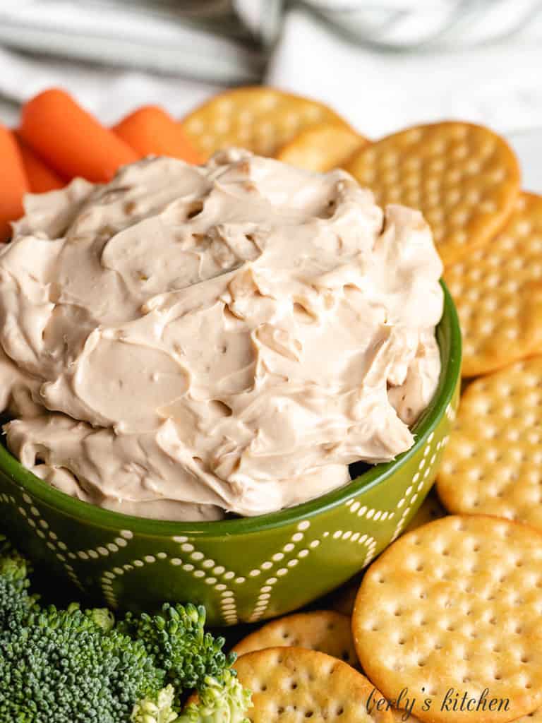 Cream cheese onion dip in a green bowl.