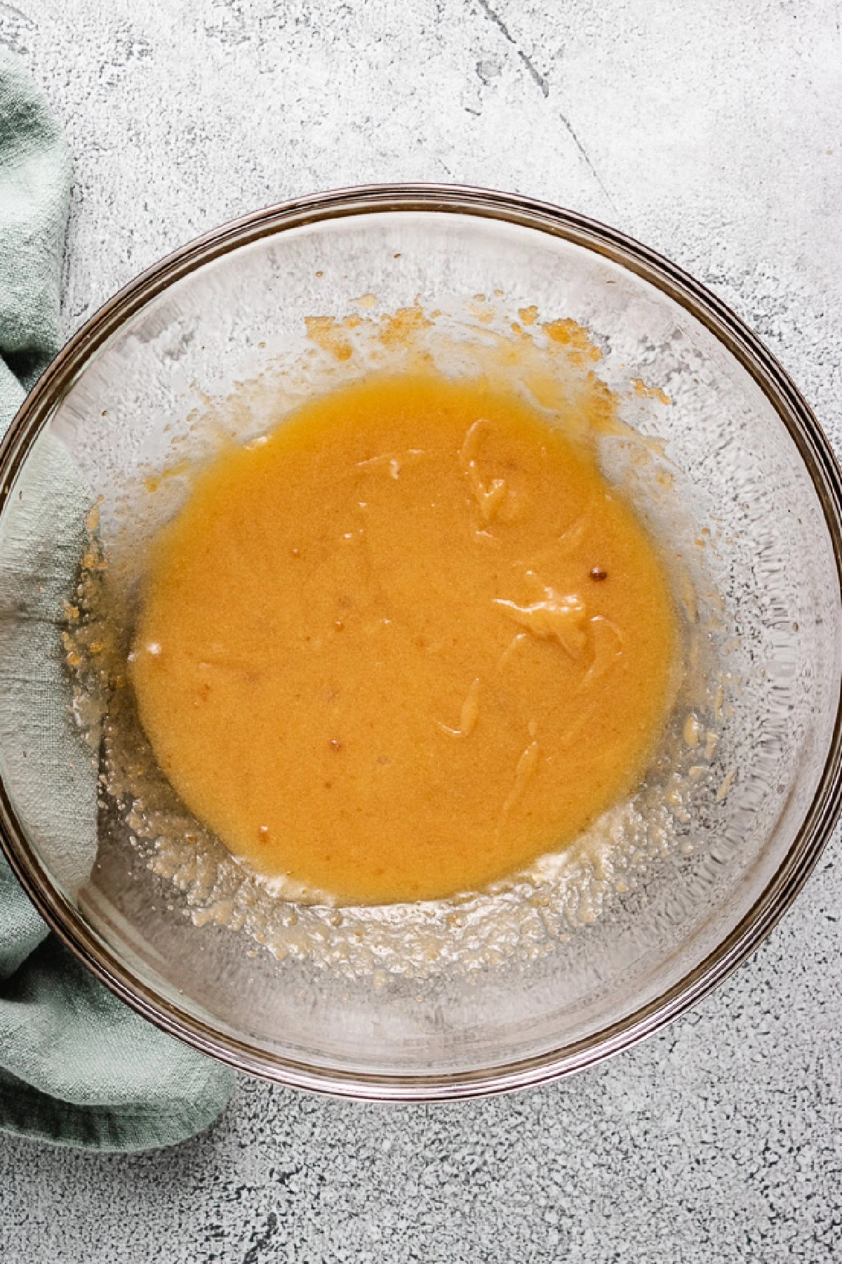 Eggs vanilla and sugar mixed in a bowl.