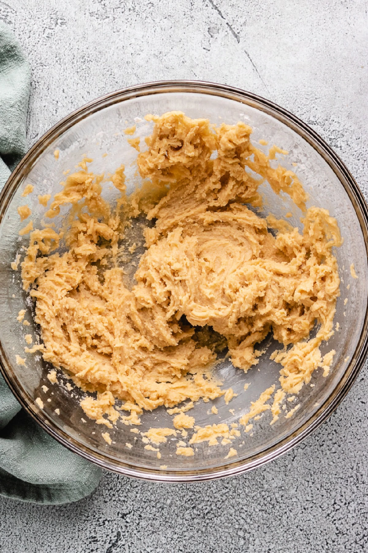 Butter, sugar, egg, and vanilla mixed in a bowl.
