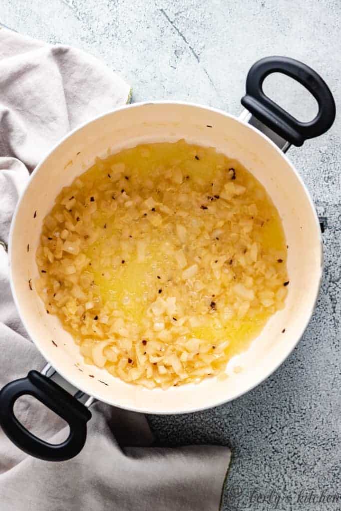 Sautéed onions, garlic, and vodka in a pan.