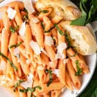 Pasta noodles, vodka sauce, basil, and Parmesan cheese.
