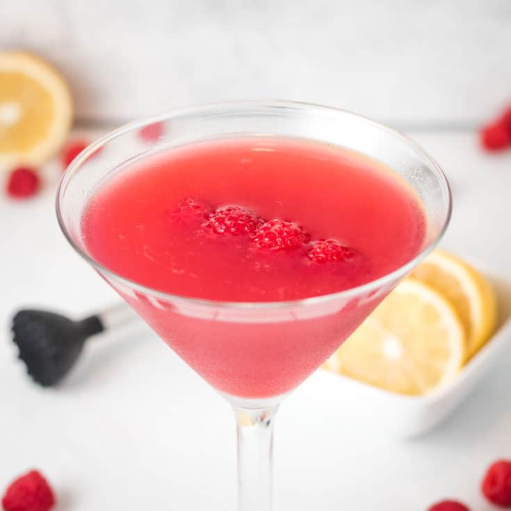 Raspberry Martini with fresh raspberries and lemon.
