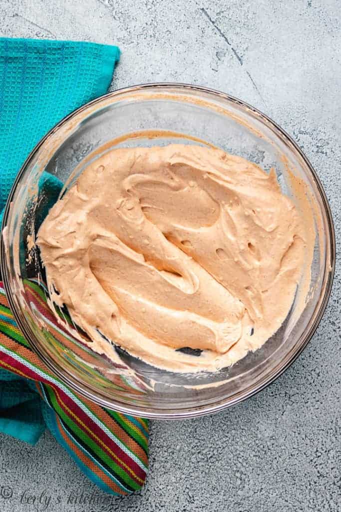 Cream cheese sour cream mixture with taco seasoning in a bowl.