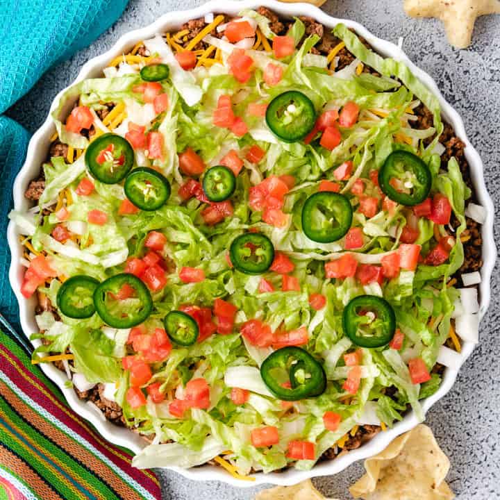 Top down view of taco dip in a dish with chips.