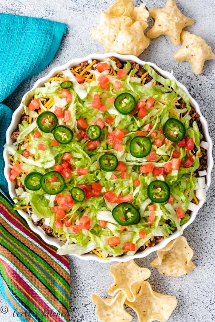 Top down view of taco dip in a dish with chips.