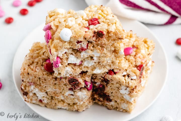 Three large rice krispie treats on a plate.