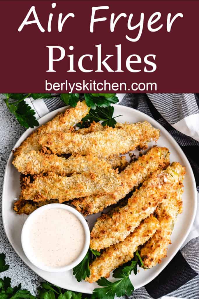 Air fryer pickles on a plate with dipping sauce.