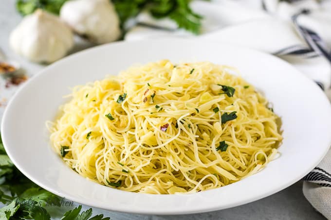 Angel hair pasta recipe garnished with Italian parsley.