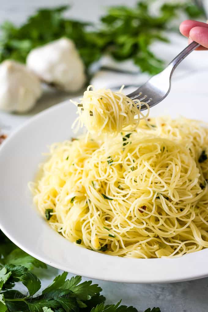 The noodles being lifted out of a bowl with a fork.