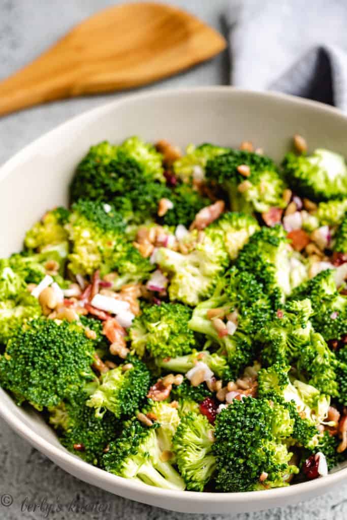 Broccoli salad with bacon in a gray bowl.