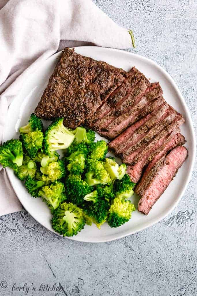 Top down view of steak and veggies on a plate.