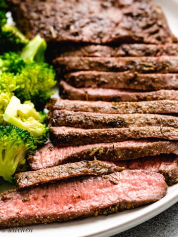 Flat iron steak and broccoli on a plate.