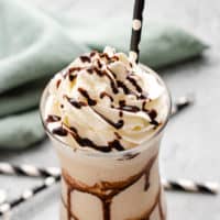 Frozen mudslide in a glass with a black straw.